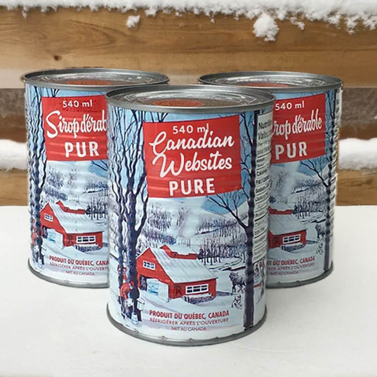 Maple Syrup cans on a snowy wood background. The can label reads Canadian Websites PURE